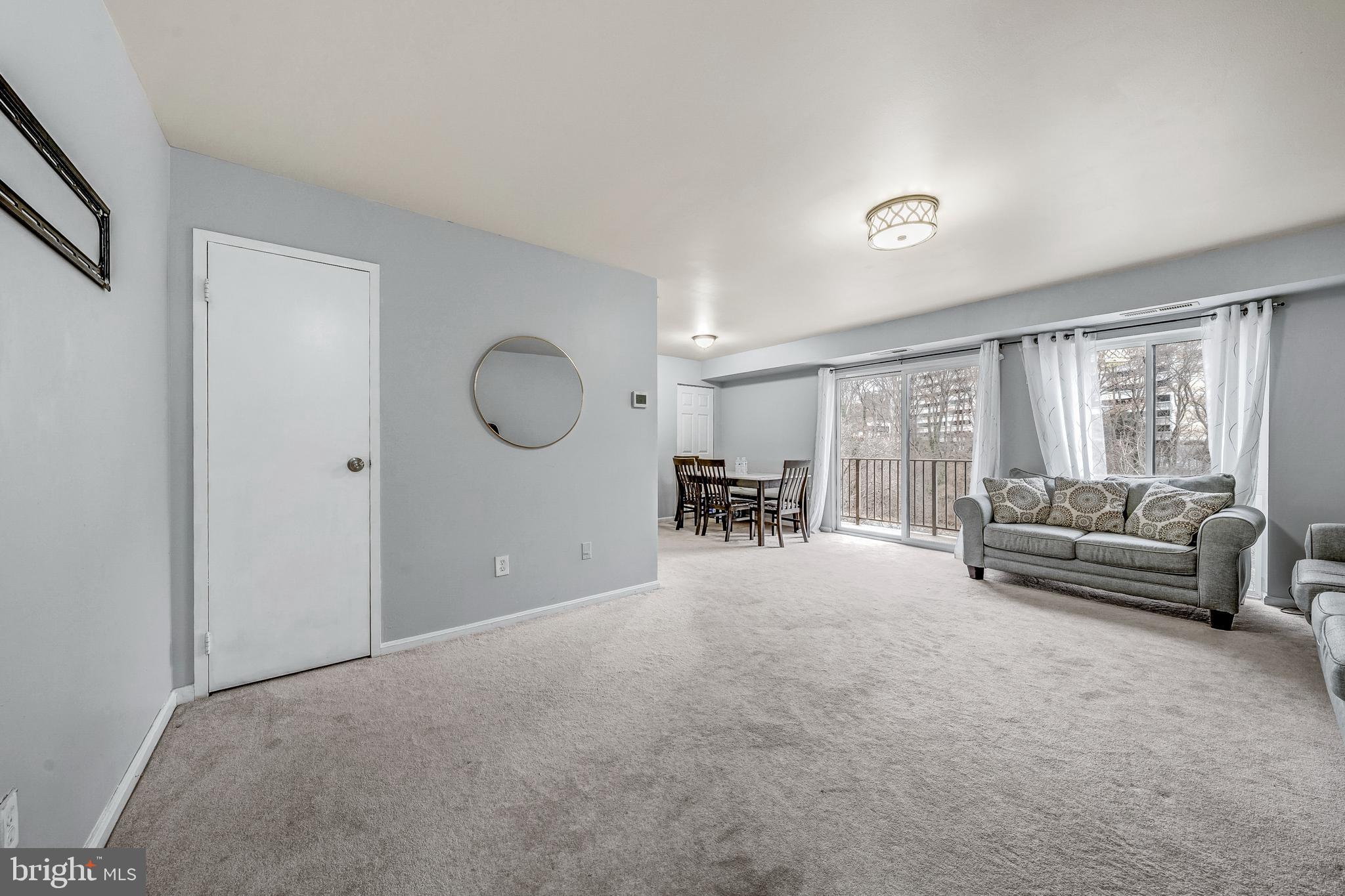 6137 Edsall Road, Unit I Alexandria, VA 22304 - Photo 6 of 28 a living room with furniture a window and gym equipment