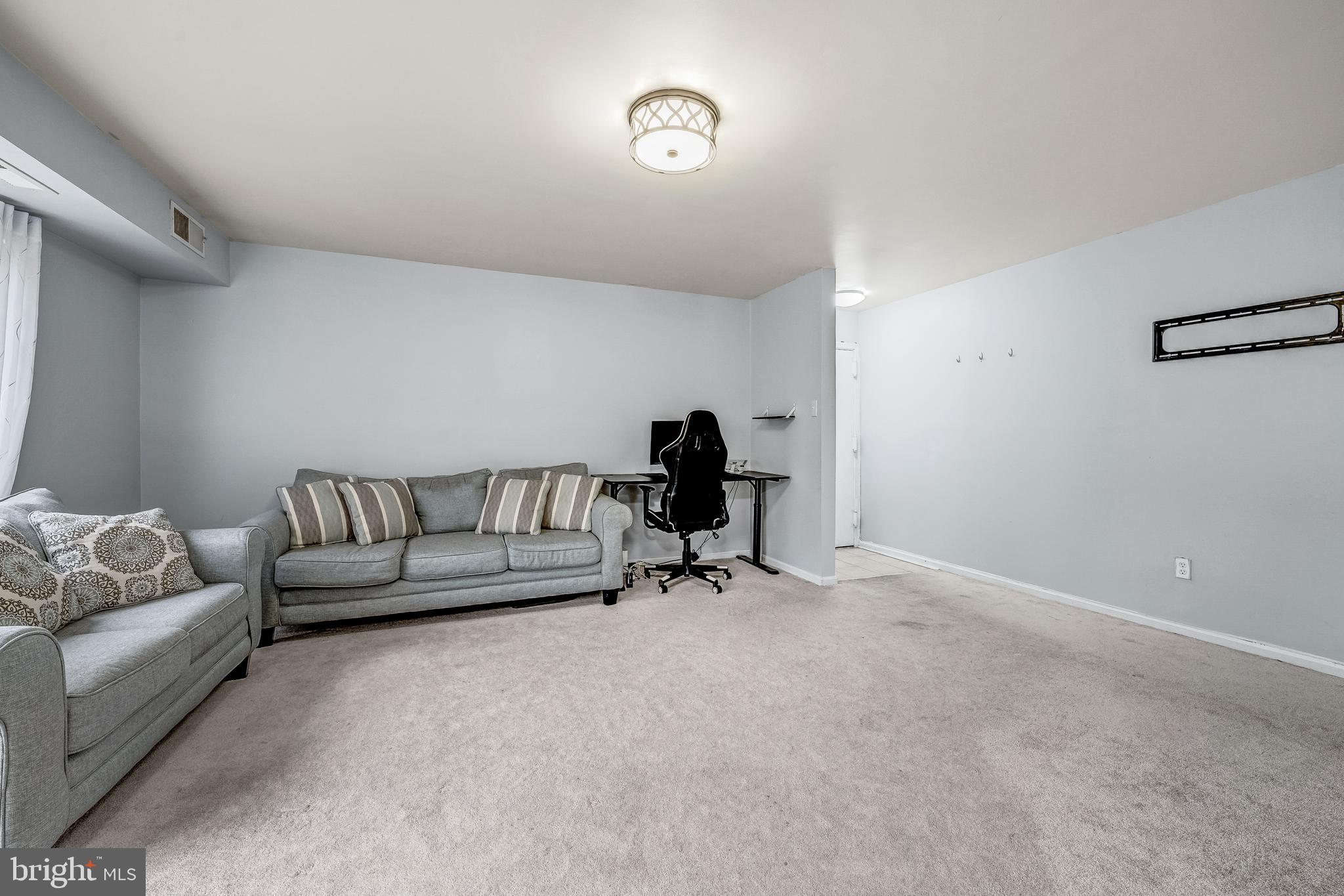 6137 Edsall Road, Unit I Alexandria, VA 22304 - Photo 7 of 28 a living room with furniture and a window