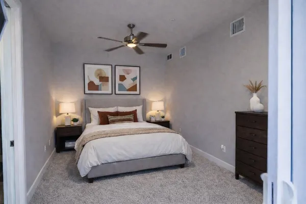 a bedroom with a bed and cabinet