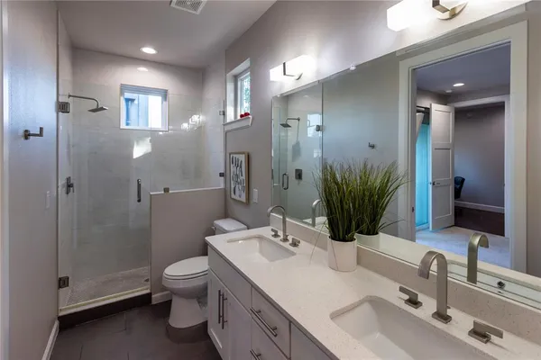 a bathroom with a sink toilet and shower