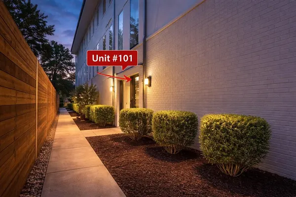 a view of a street with potted plants