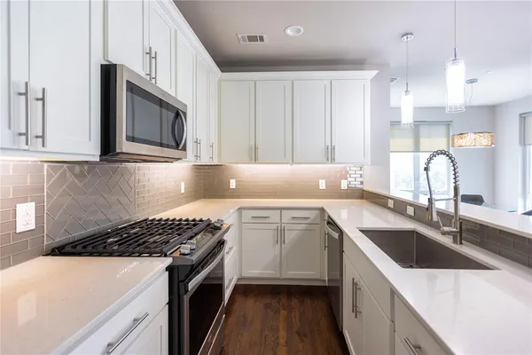 a kitchen that has a sink and a stove