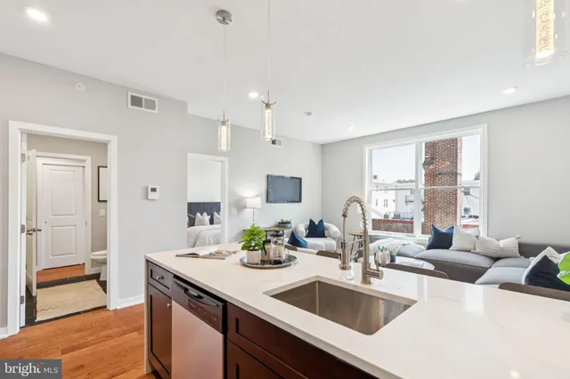 a kitchen with granite countertop a sink and cabinets