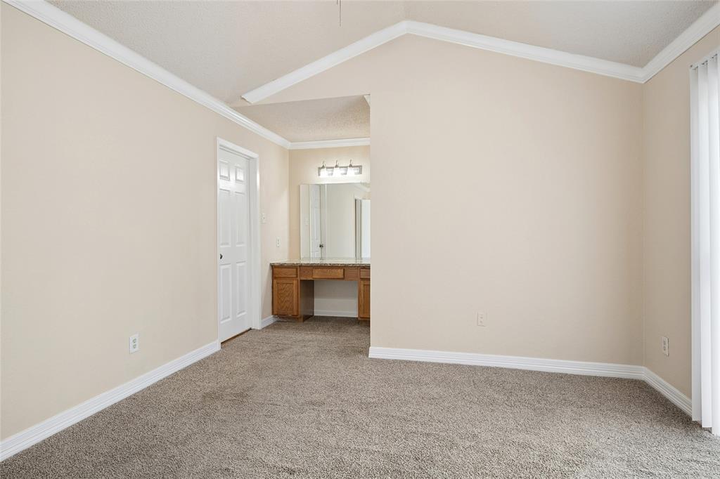 2400 Jupiter Road, Unit B9 Plano, TX 75074 - Photo 9 of 15 Bedroom has high ceilings, crown molding and built in vanity.