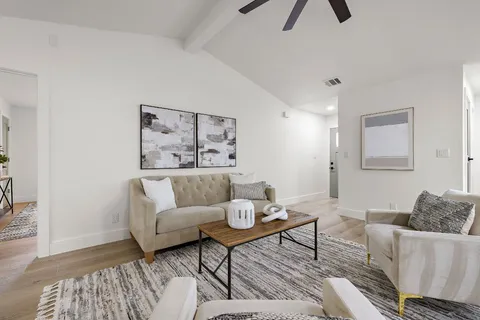 a living room with furniture and kitchen view