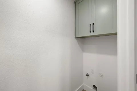 a view of a room with wooden floor and a ceiling fan