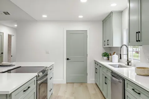 a kitchen that has a stove and a table in it