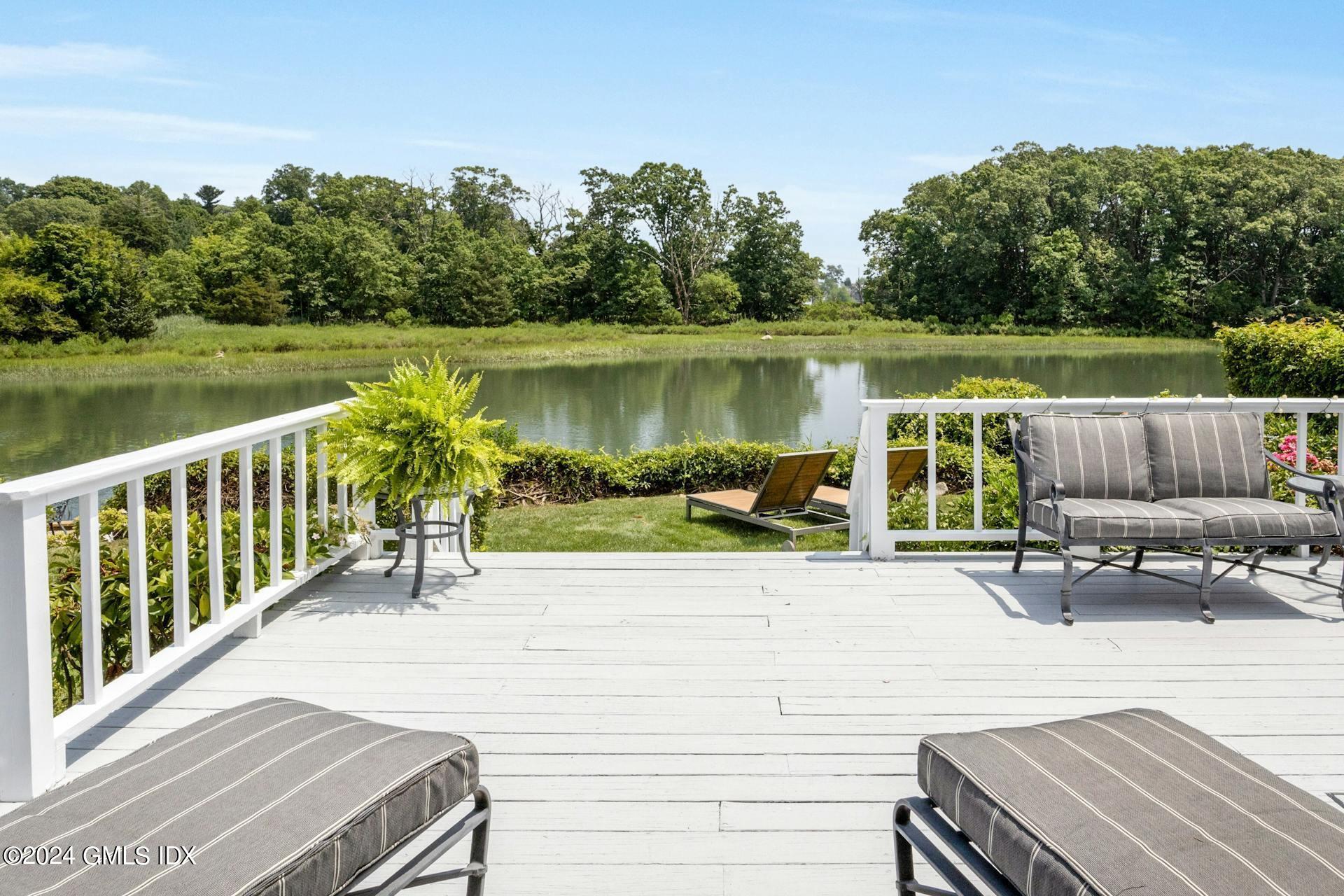 61 Roton Avenue Norwalk, CT 06853 - Photo 19 of 31 a view of a patio with lawn chairs next to a yard