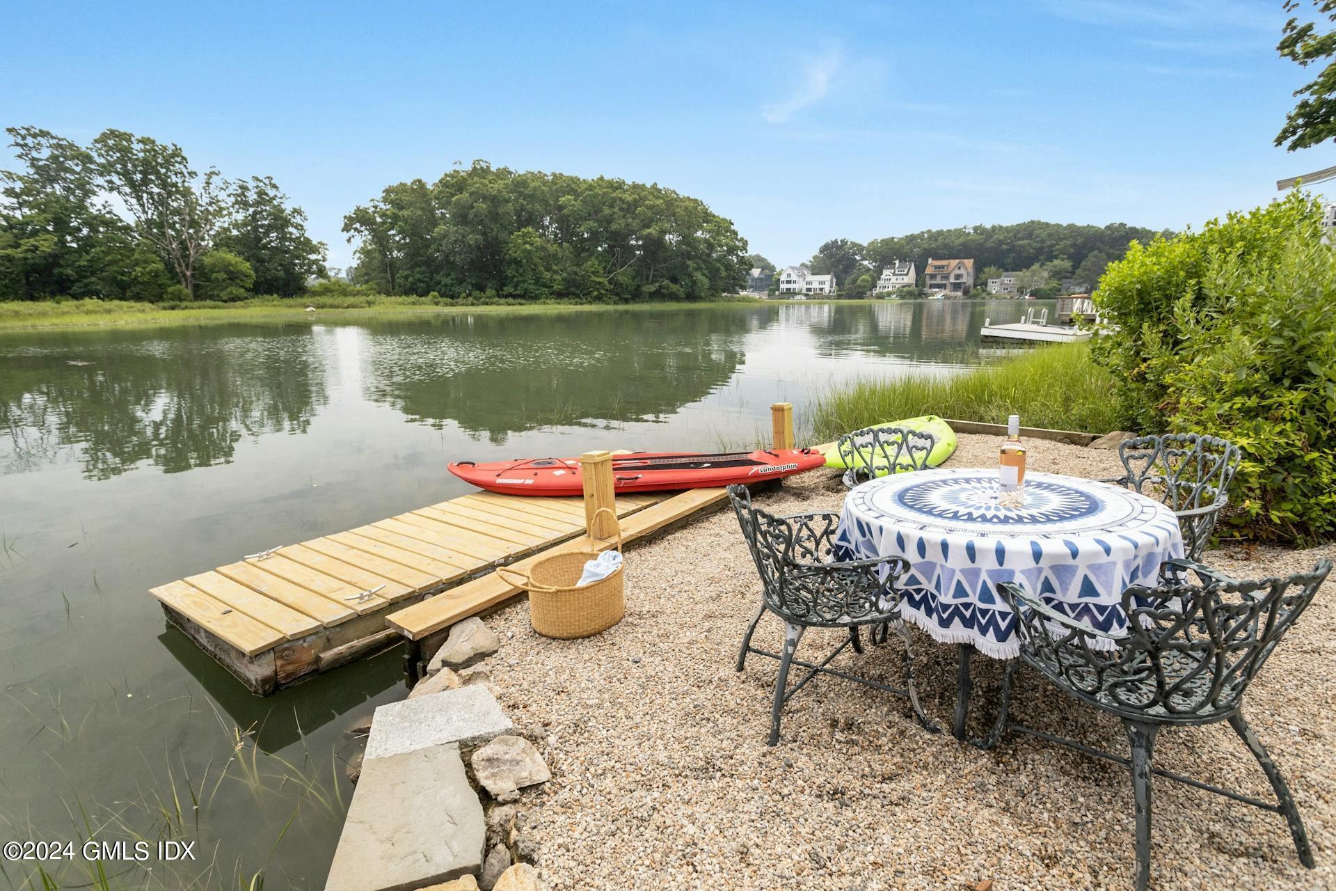 61 Roton Avenue Norwalk, CT 06853 - Photo 24 of 31 a view of a lake with a table and chairs