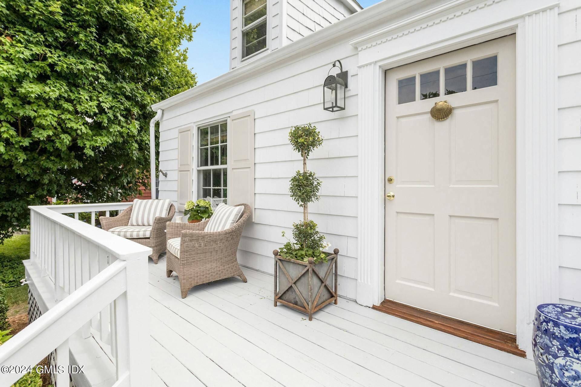 61 Roton Avenue Norwalk, CT 06853 - Photo 4 of 31 a white house with a table and chairs