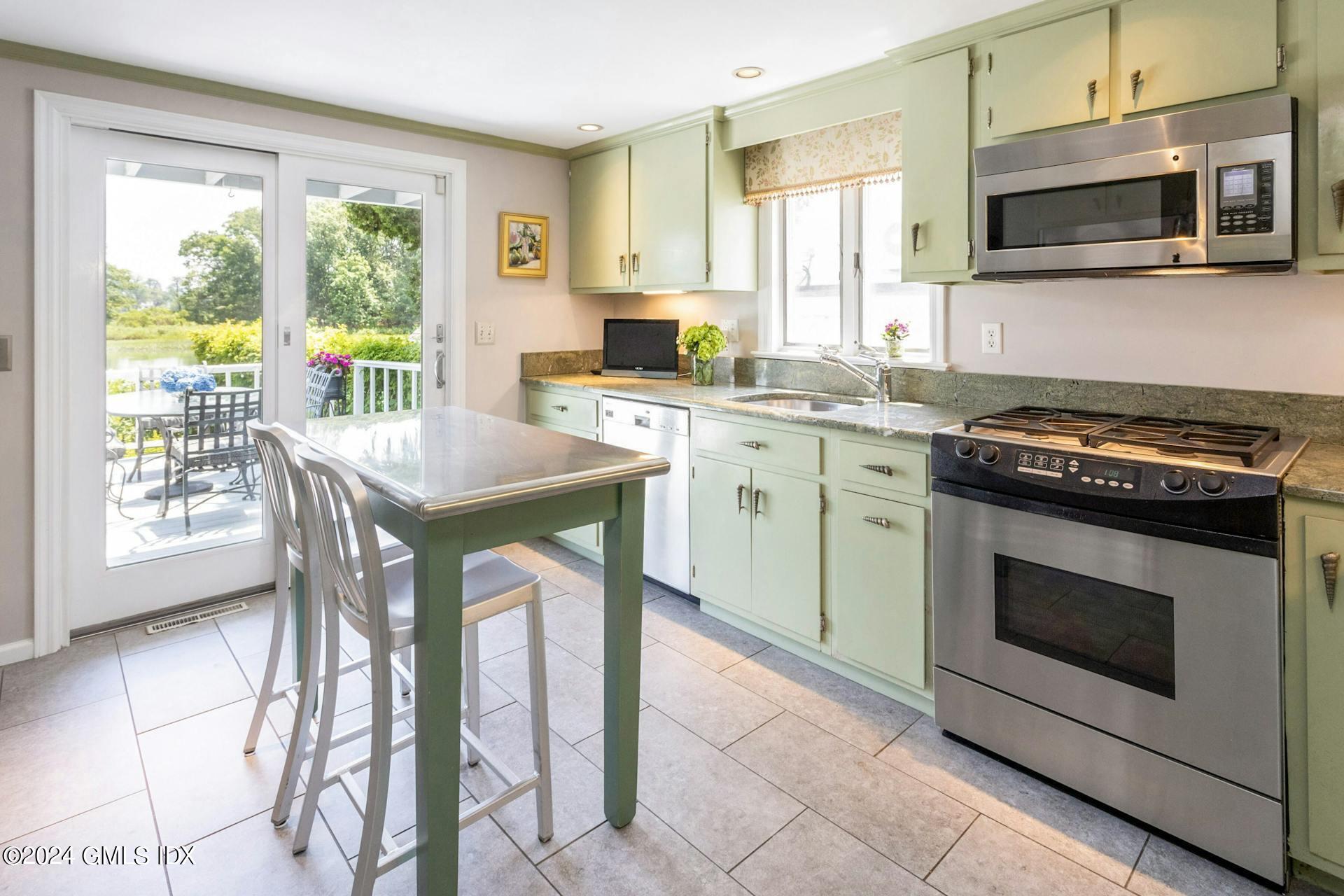 61 Roton Avenue Norwalk, CT 06853 - Photo 9 of 31 a kitchen with stainless steel appliances granite countertop a stove microwave and sink