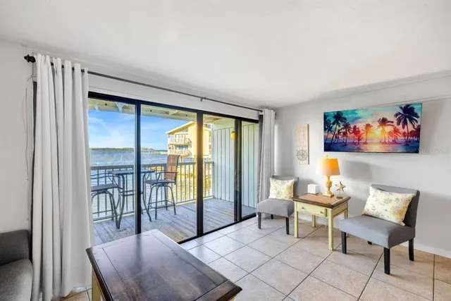 a living room with furniture a rug and a large window