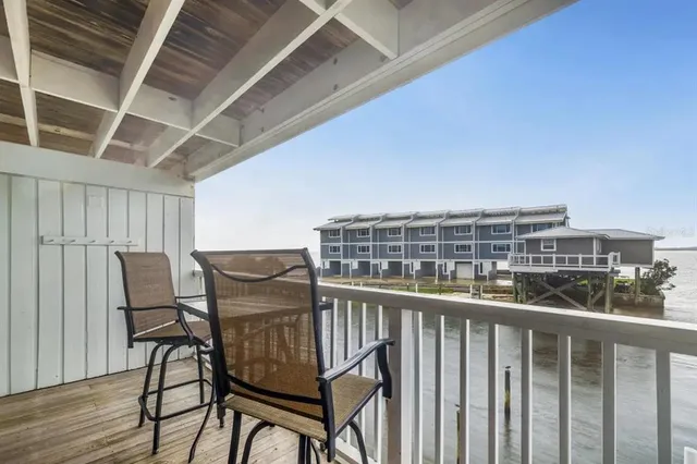 a view of balcony with wooden floor and outdoor seating