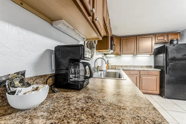 a kitchen with refrigerator and stove