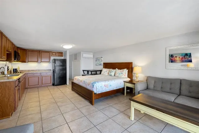 a bedroom with a bed and a couch