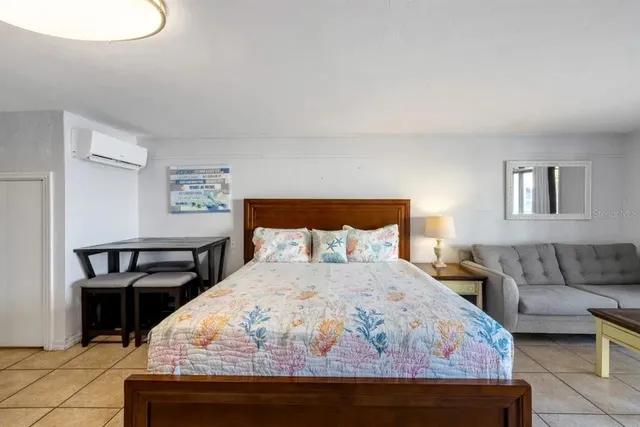 a bedroom with a bed and a couch