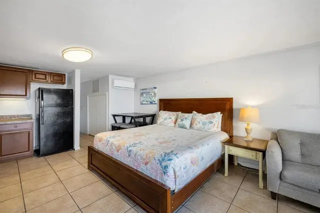 a bedroom with a bed and a couch