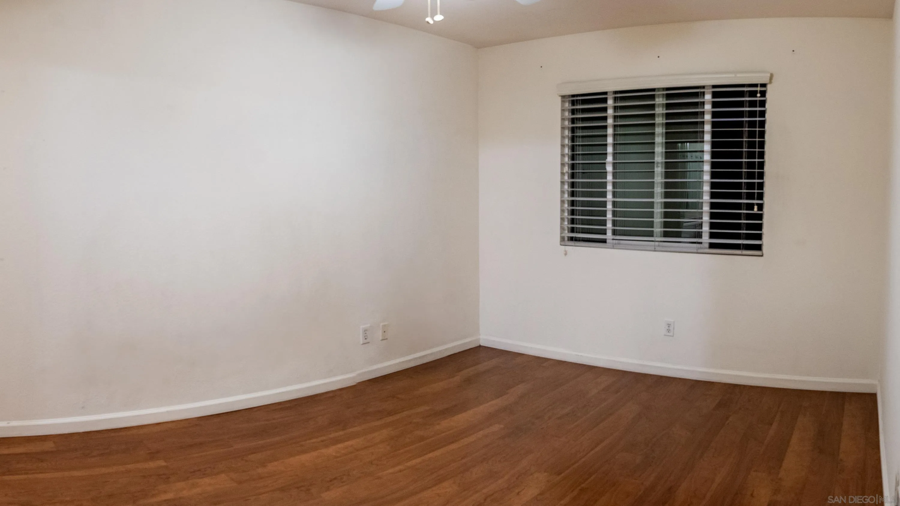 1246 Stagecoach Trail Loop Chula Vista, CA 91915 - Photo 11 of 17 a view of an empty room with wooden floor and windows