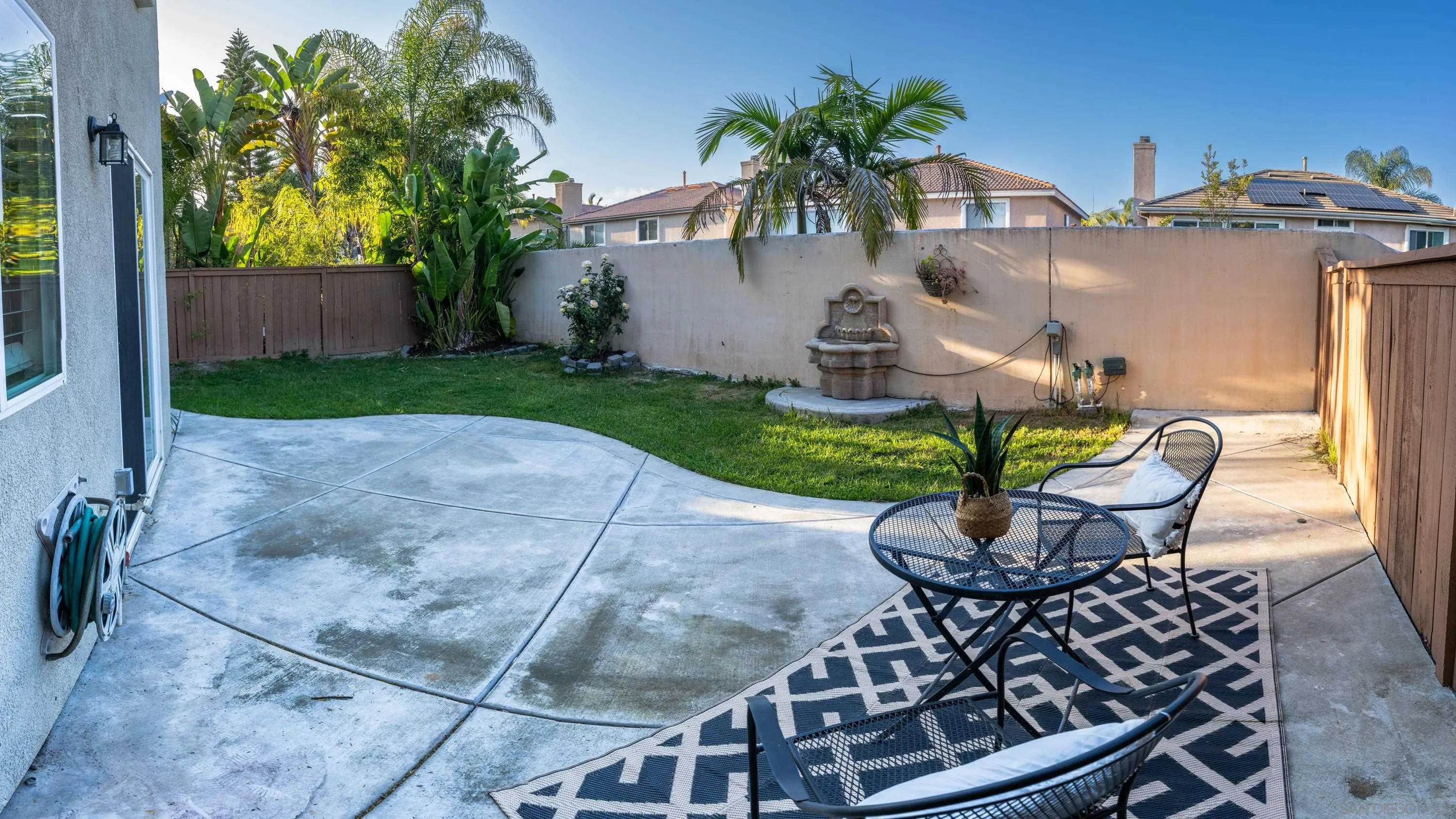 1246 Stagecoach Trail Loop Chula Vista, CA 91915 - Photo 13 of 17 a view of a backyard with table and chairs and potted plants