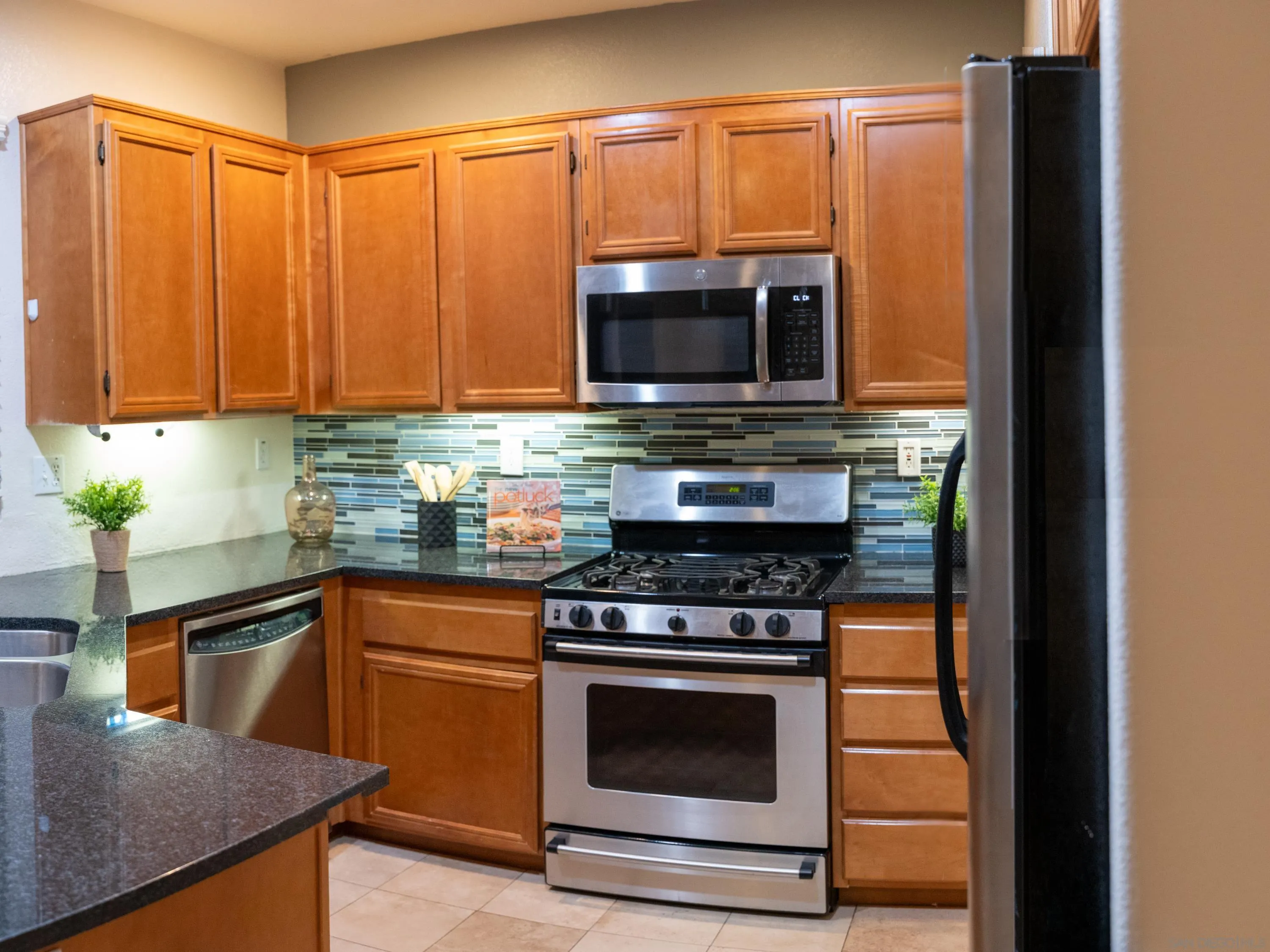 1246 Stagecoach Trail Loop Chula Vista, CA 91915 - Photo 6 of 17 a kitchen with a stove and a microwave