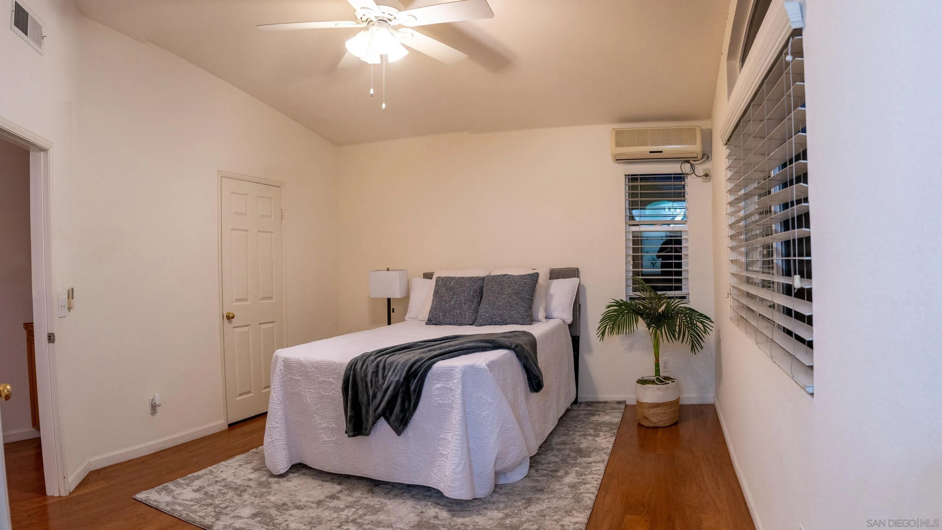 1246 Stagecoach Trail Loop Chula Vista, CA 91915 - Photo 7 of 17 a spacious bedroom with a bed and a chandelier