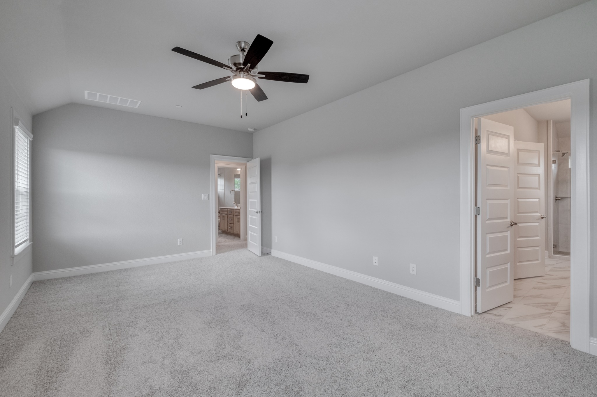 2605 Sam Bass Road, Unit 44 Round Rock, TX 78681 - Photo 17 of 26 A spacious primary bedroom retreat with soft carpeting and direct access to a gorgeous private bathroom.
