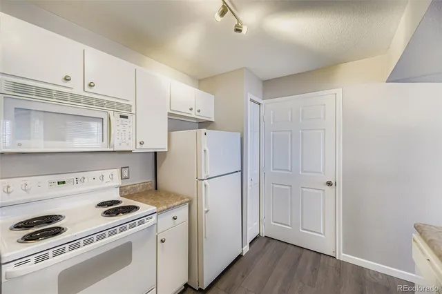 a spacious bedroom with a bed and a ceiling fan