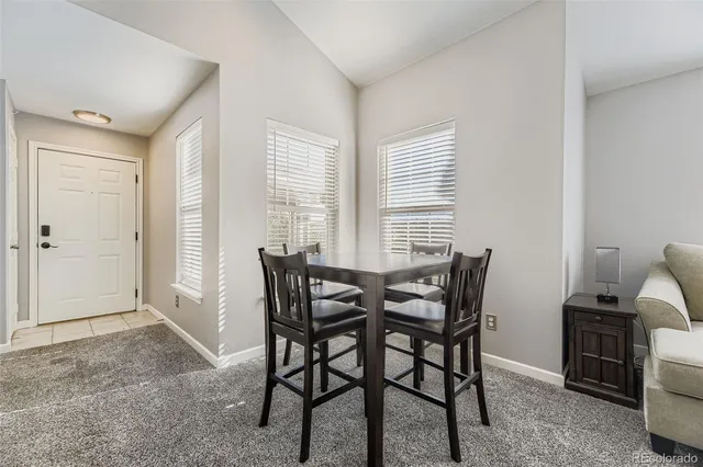 a view of a dining room with furniture and window
