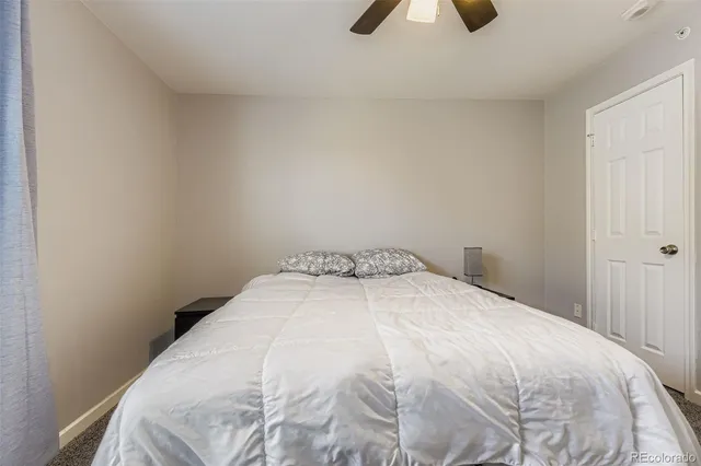 a large bed sitting in a bedroom next to a window