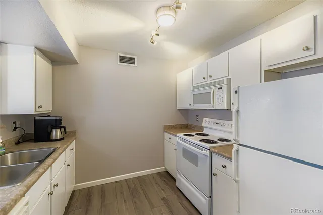 a kitchen with a sink and cabinets