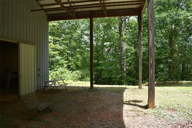 a view of a yard with table and chairs and wooden fence