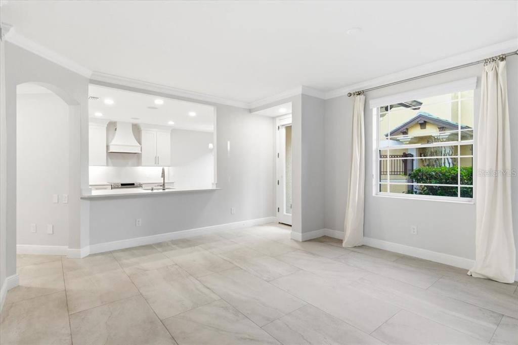 6536 Moorings Point Circle, Unit 101 Lakewood Ranch, FL 34202 - Photo 13 of 48 a view of an empty room with a kitchen