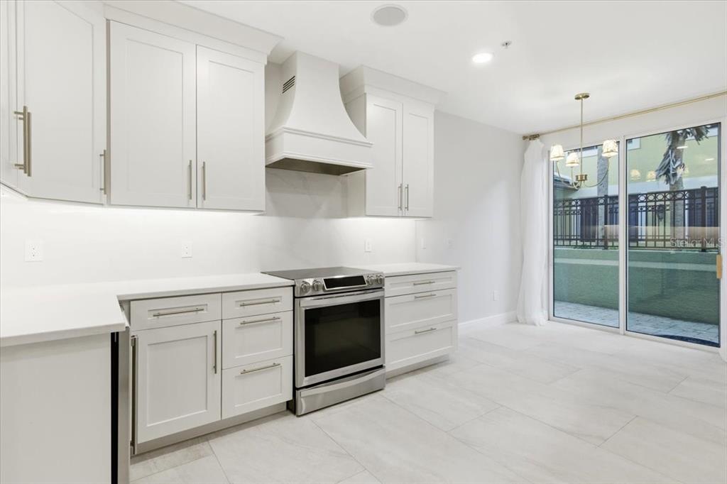 6536 Moorings Point Circle, Unit 101 Lakewood Ranch, FL 34202 - Photo 16 of 48 a kitchen with stainless steel appliances granite countertop a stove and a sink