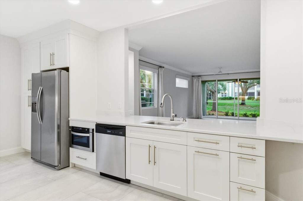 6536 Moorings Point Circle, Unit 101 Lakewood Ranch, FL 34202 - Photo 19 of 48 a kitchen with a sink and refrigerator