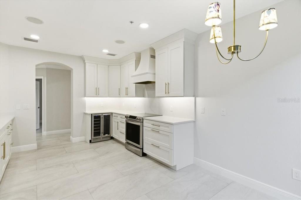 6536 Moorings Point Circle, Unit 101 Lakewood Ranch, FL 34202 - Photo 22 of 48 a kitchen with white cabinets and a stove