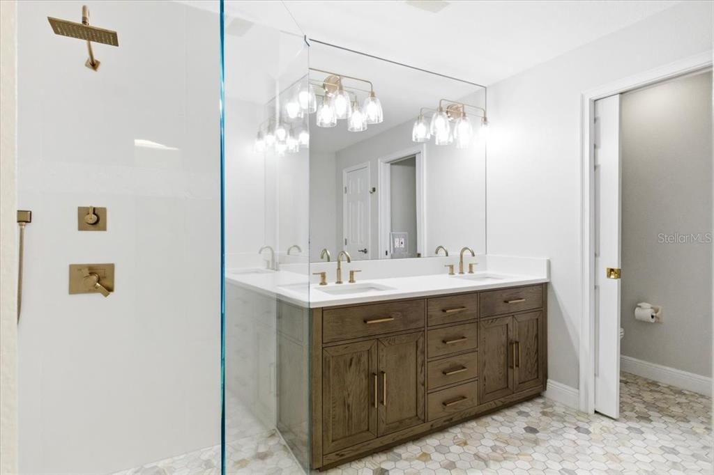 6536 Moorings Point Circle, Unit 101 Lakewood Ranch, FL 34202 - Photo 29 of 48 a bathroom with a double vanity sink and a mirror