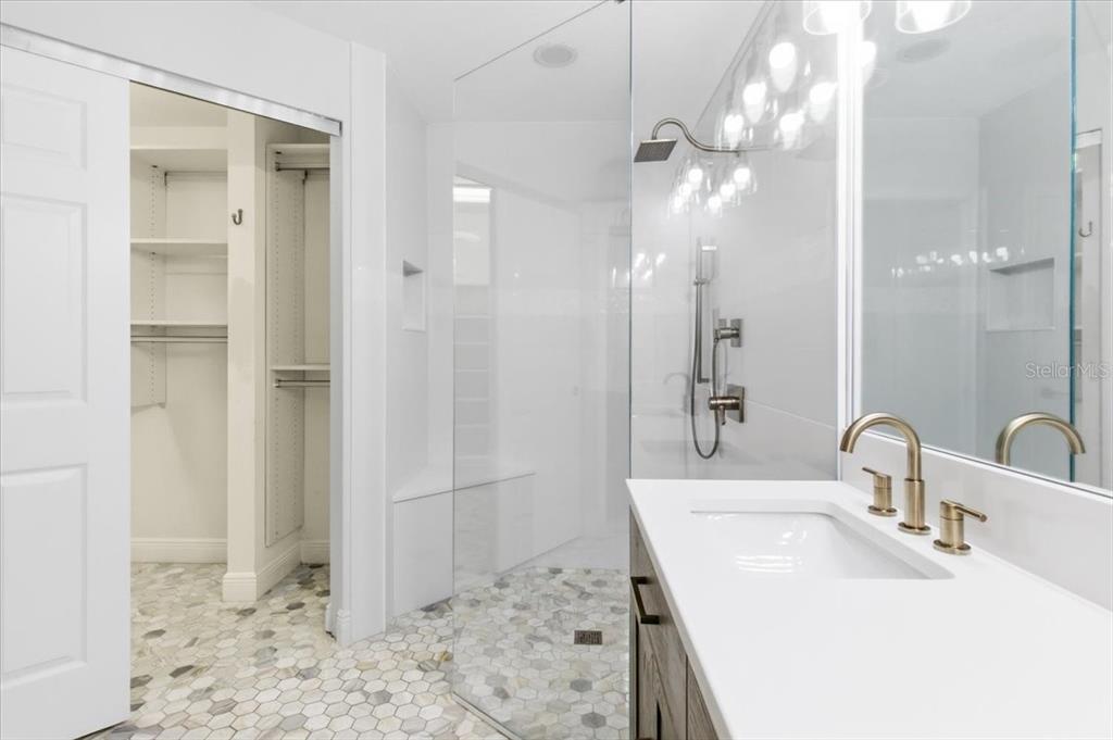 6536 Moorings Point Circle, Unit 101 Lakewood Ranch, FL 34202 - Photo 30 of 48 a bathroom with a sink a toilet and shower