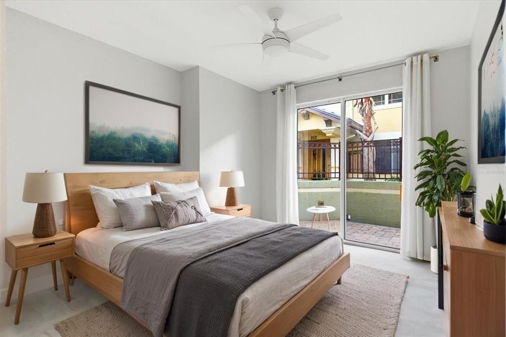 6536 Moorings Point Circle, Unit 101 Lakewood Ranch, FL 34202 - Photo 35 of 48 a bedroom with a large bed and a potted plant