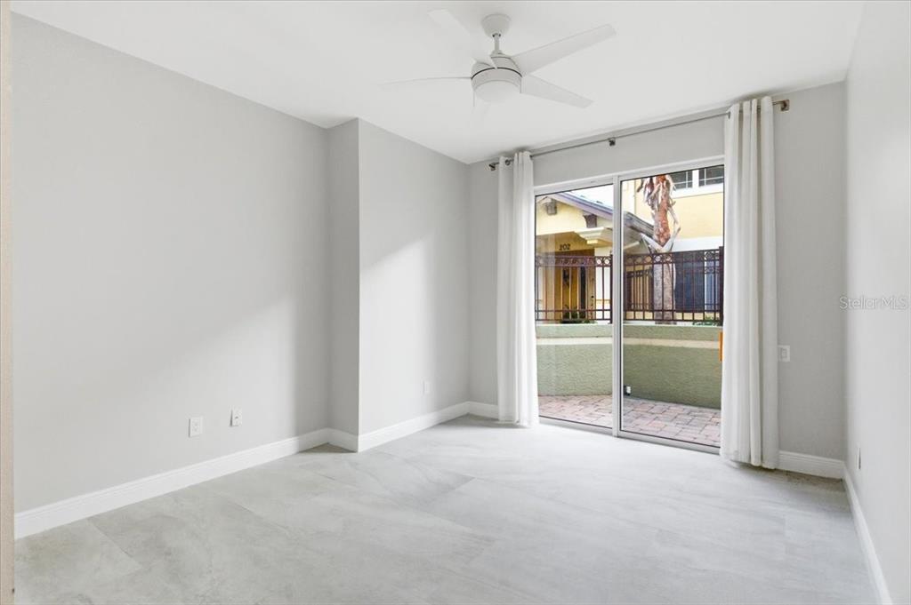 6536 Moorings Point Circle, Unit 101 Lakewood Ranch, FL 34202 - Photo 36 of 48 an empty room with fan and windows