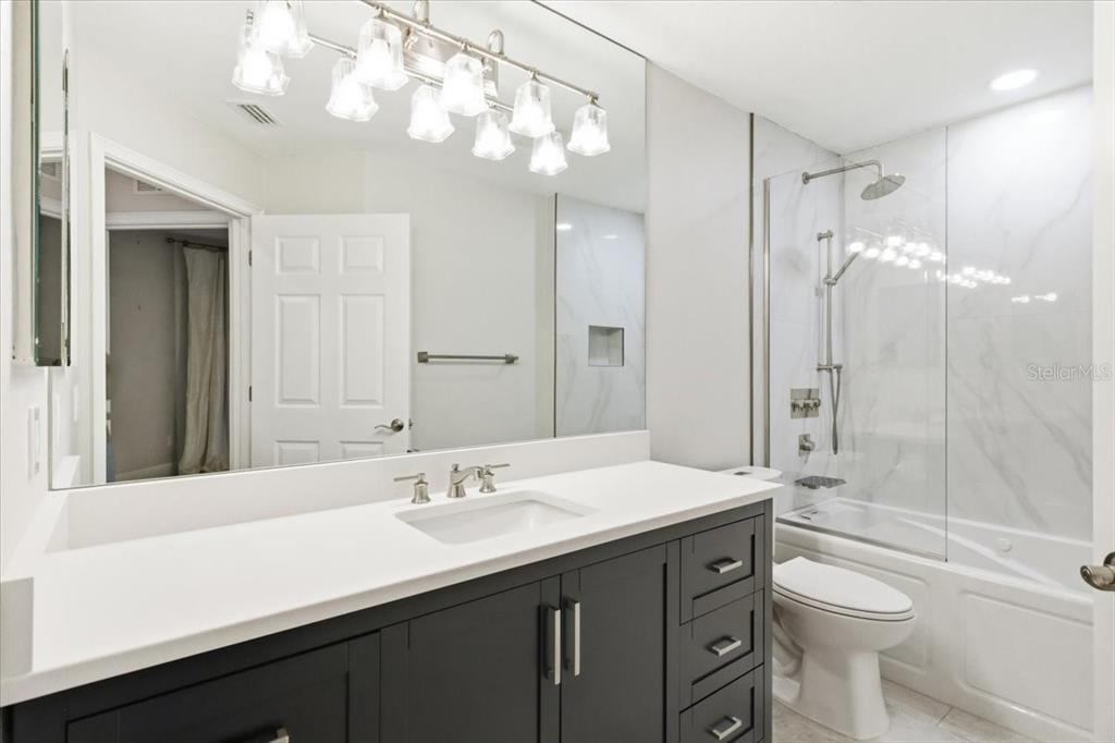 6536 Moorings Point Circle, Unit 101 Lakewood Ranch, FL 34202 - Photo 38 of 48 a bathroom with a sink a toilet and shower