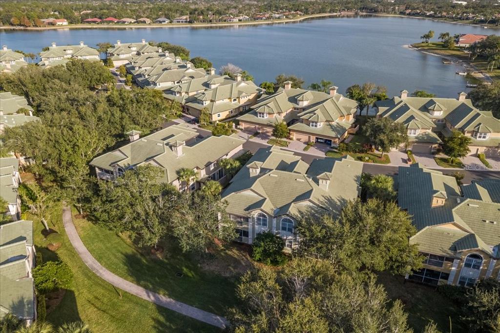 6536 Moorings Point Circle, Unit 101 Lakewood Ranch, FL 34202 - Photo 43 of 48 a view of a lake with lawn chairs