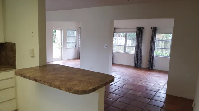 a view of a backyard with a wooden fence and a bench