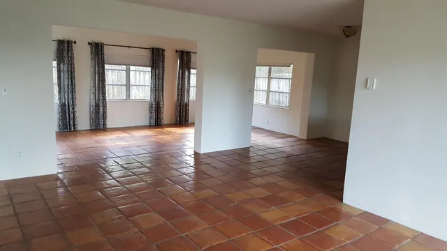 an empty room with windows and closet