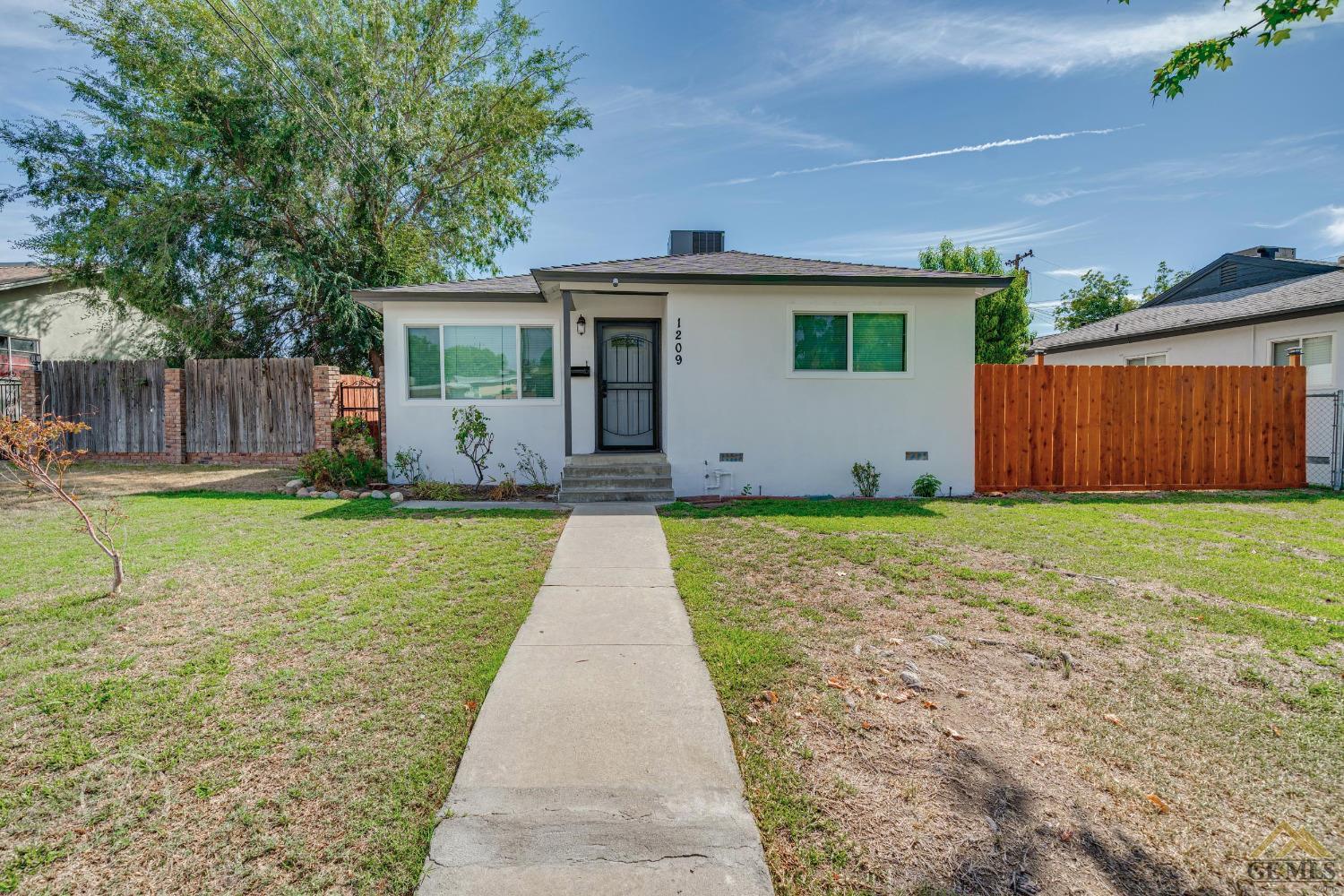 Undisclosed Address Bakersfield, CA 93305 - Photo 1 of 28 a front view of house with a garden
