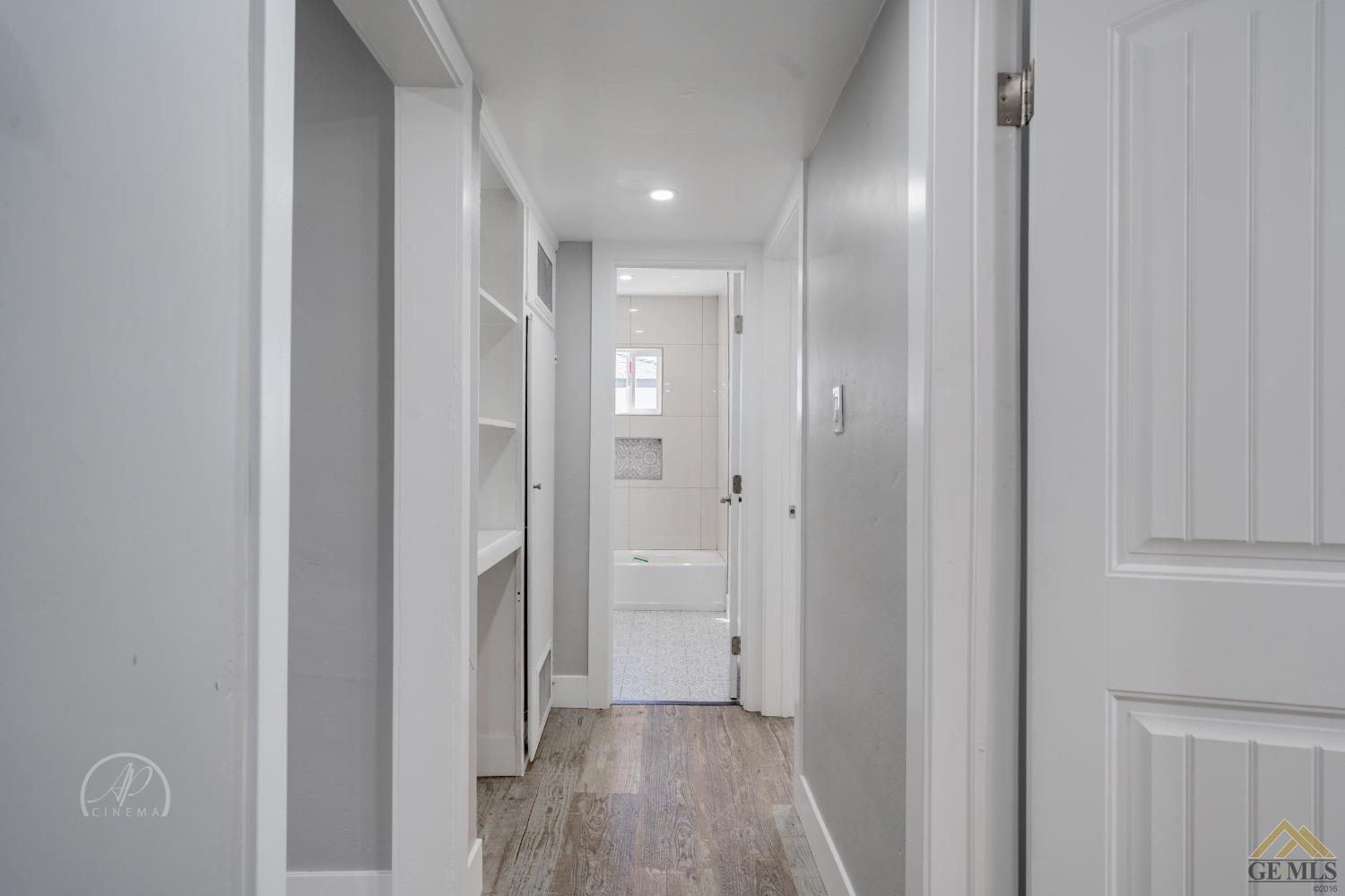 Undisclosed Address Bakersfield, CA 93305 - Photo 11 of 28 a view of a hallway with wooden floor
