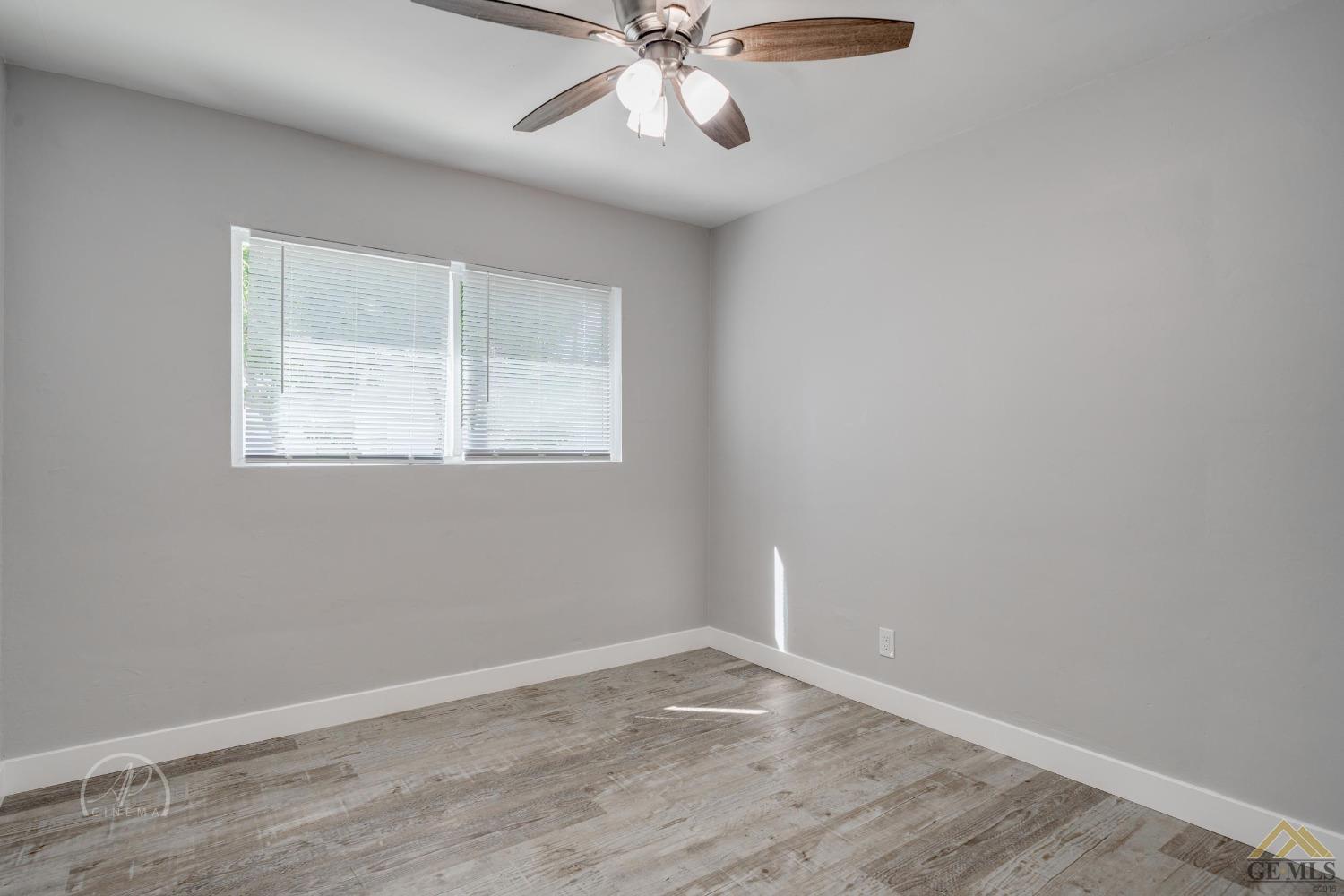 Undisclosed Address Bakersfield, CA 93305 - Photo 12 of 28 an empty room with a window and a fan