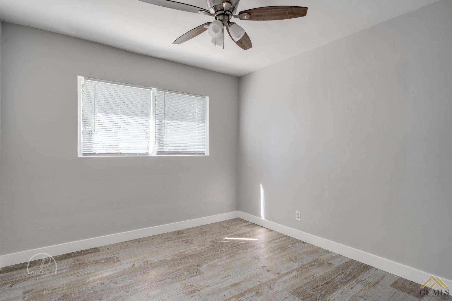 Undisclosed Address Bakersfield, CA 93305 - Photo 13 of 28 an empty room with a window and a fan