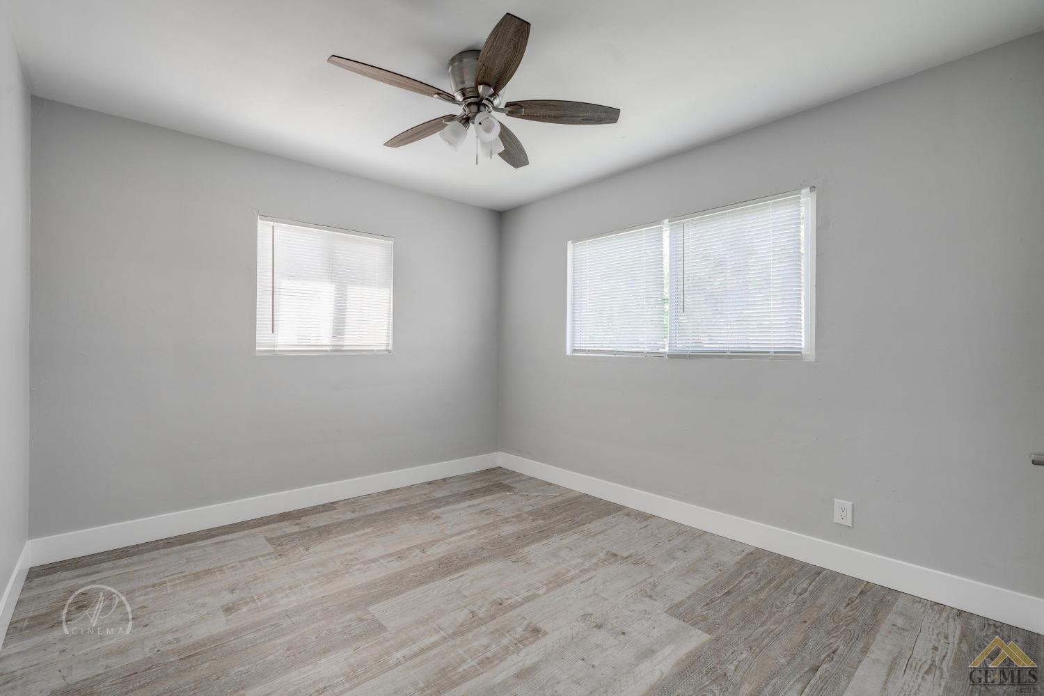 Undisclosed Address Bakersfield, CA 93305 - Photo 14 of 28 a view of a room with wooden floor and a ceiling fan