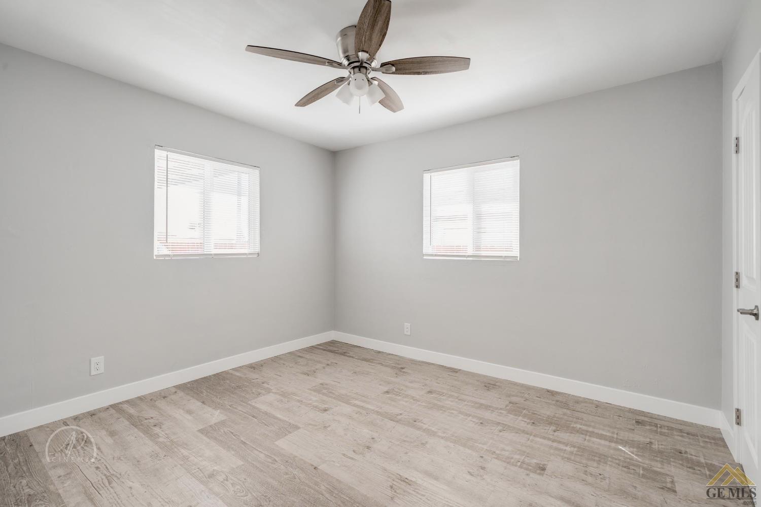 Undisclosed Address Bakersfield, CA 93305 - Photo 16 of 28 an empty room with windows and fan