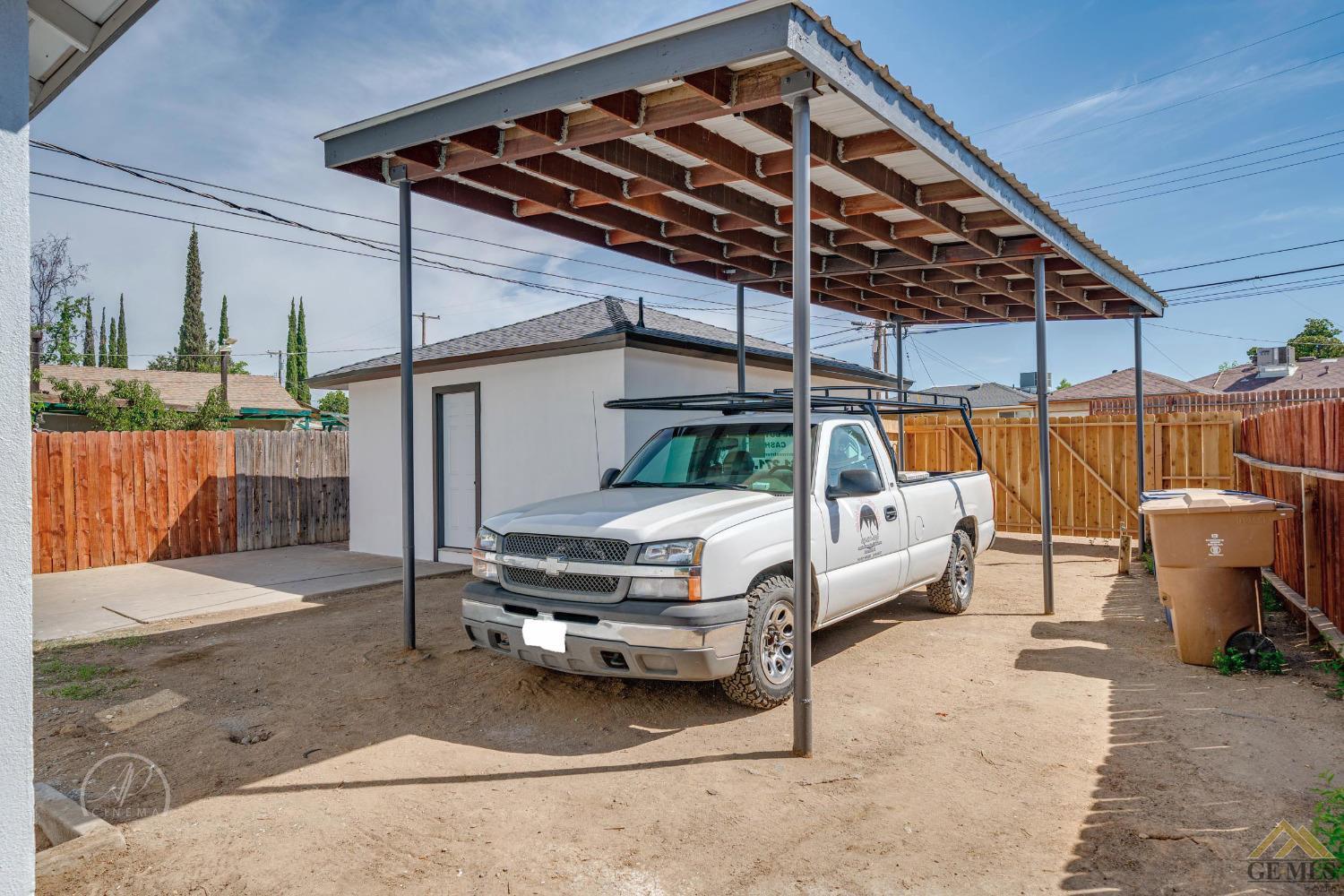 Undisclosed Address Bakersfield, CA 93305 - Photo 22 of 28 a white car parked in front of a house